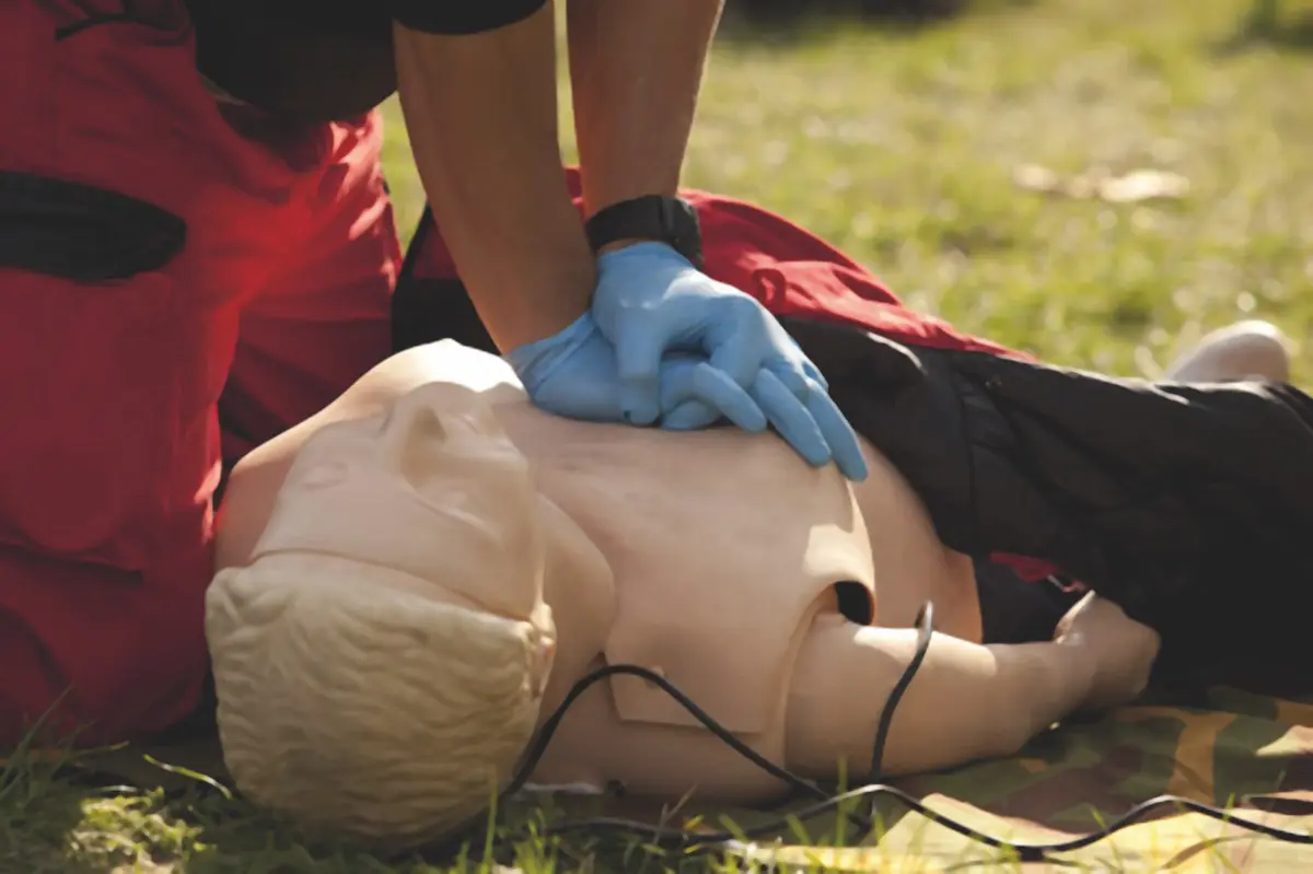 Un formateur montre la position latérale de sécurité à un groupe de salariés lors d’une session de formation Sauveteur Secouriste du Travail en entreprise.